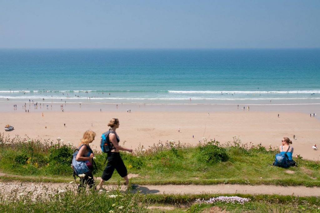 Holidaymakers at beach near holiday accommodation in Newquay by Forever Cornwall